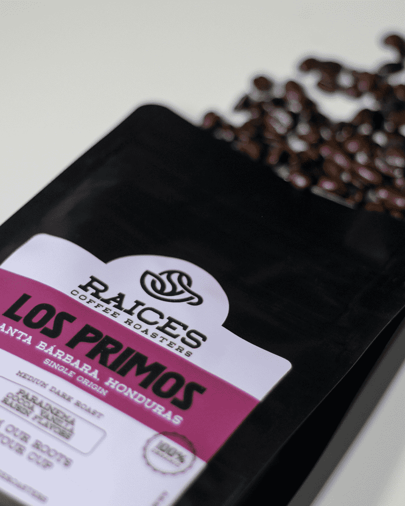 Los Primos Parainema Honduran coffee bag with roasted beans flat lay